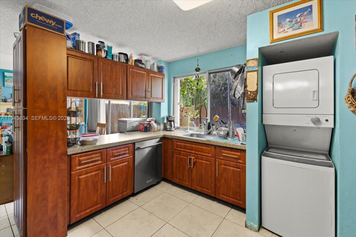 7120 Southwest 112th Avenue Miami, FL 33173 - Photo 6 of 27 a kitchen with a sink refrigerator and cabinets