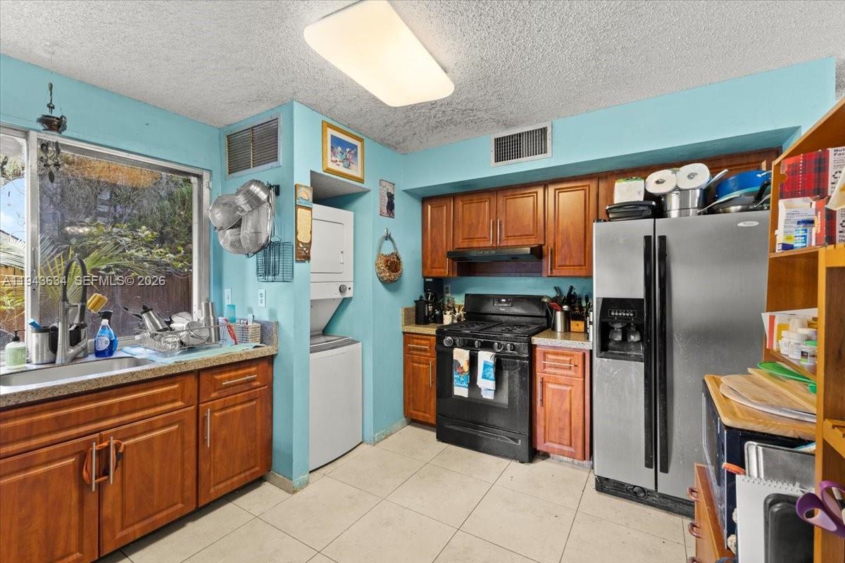7120 Southwest 112th Avenue Miami, FL 33173 - Photo 7 of 27 a kitchen with stainless steel appliances granite countertop a refrigerator and a sink