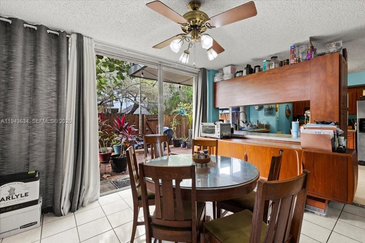 7120 Southwest 112th Avenue Miami, FL 33173 - Photo 9 of 27 a dining room with furniture a large window and a table