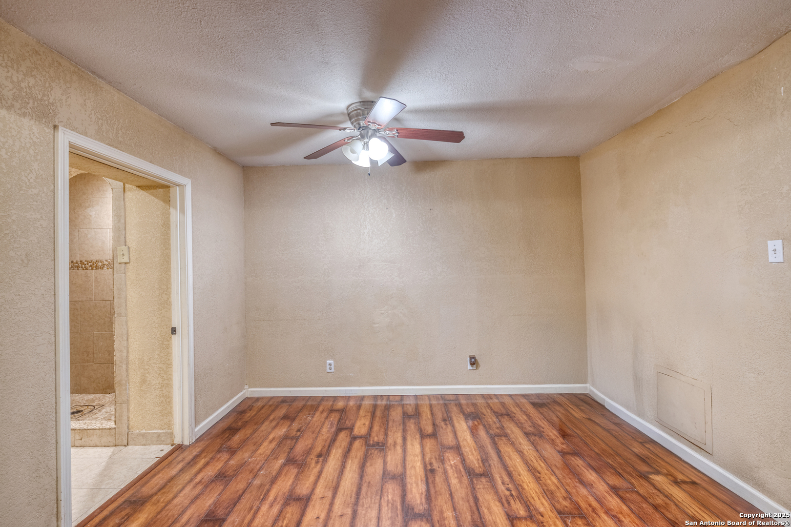 155 Avenida Juarez Road Brackettville, TX 78832 - Photo 12 of 37 wooden floor in an empty room with a window
