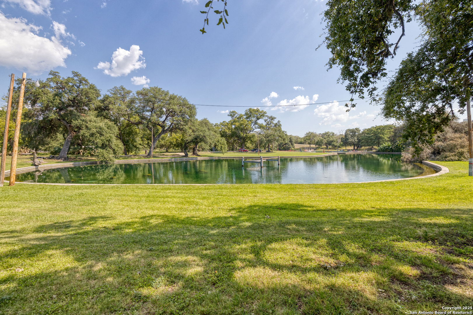 155 Avenida Juarez Road Brackettville, TX 78832 - Photo 26 of 37 a view of a lake with a big yard and large trees