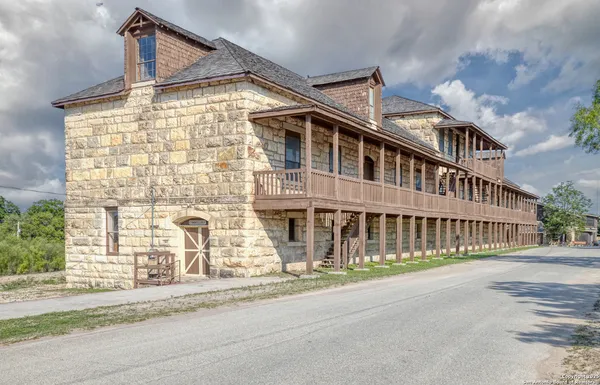 an aerial view of residential houses with outdoor space and parking