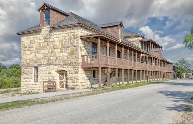an aerial view of residential houses with outdoor space and parking