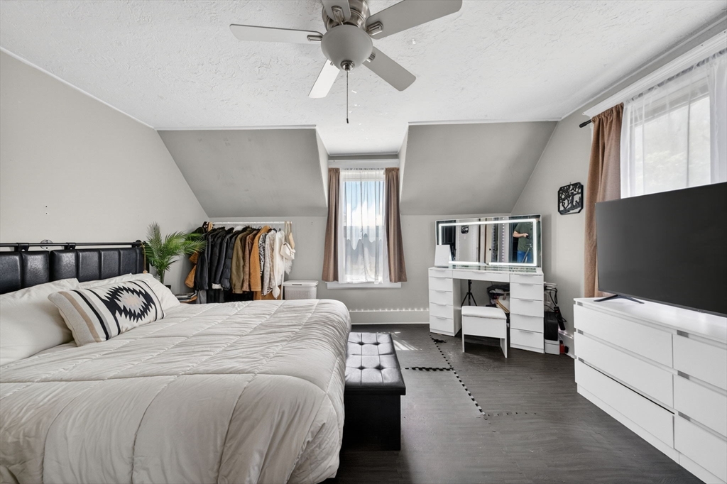 114 Lovell Street Worcester, MA 01603 - Photo 12 of 32 a bedroom with a bed and a chandelier