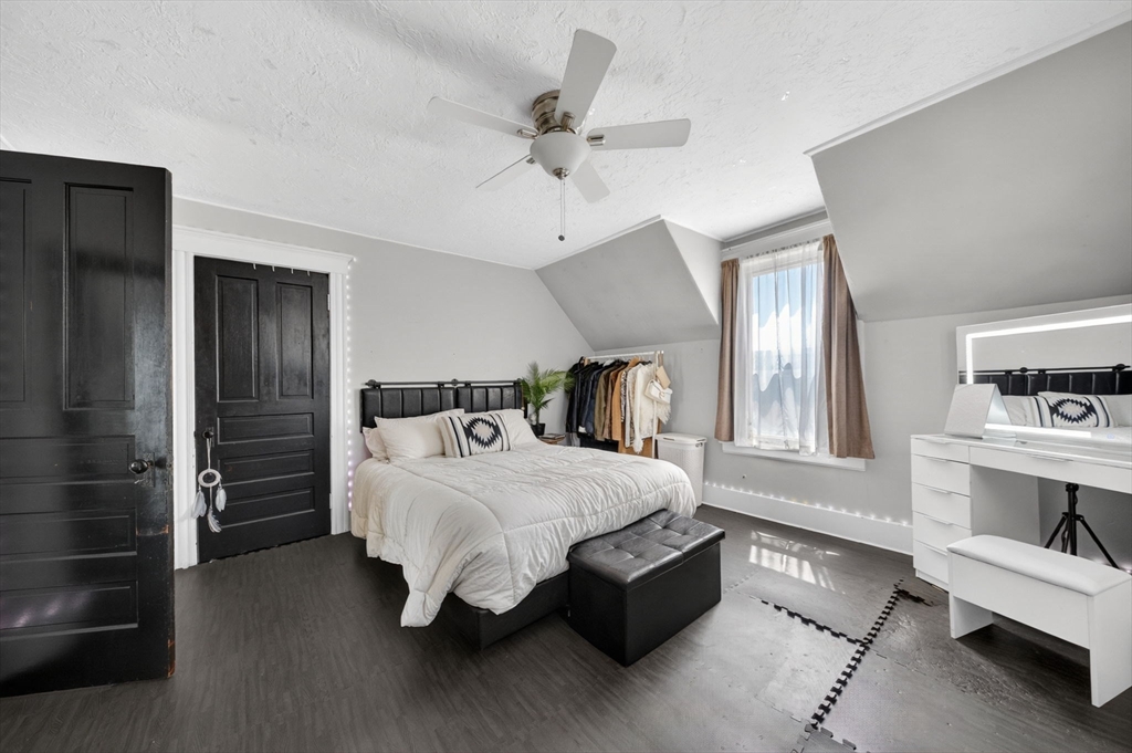 114 Lovell Street Worcester, MA 01603 - Photo 13 of 32 a bedroom with a bed and a chandelier