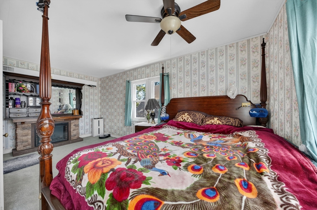 114 Lovell Street Worcester, MA 01603 - Photo 15 of 32 a bedroom with a bed and a chandelier