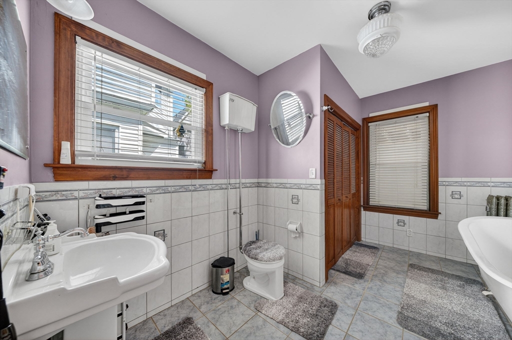 114 Lovell Street Worcester, MA 01603 - Photo 17 of 32 a bathroom with a sink a toilet and shower