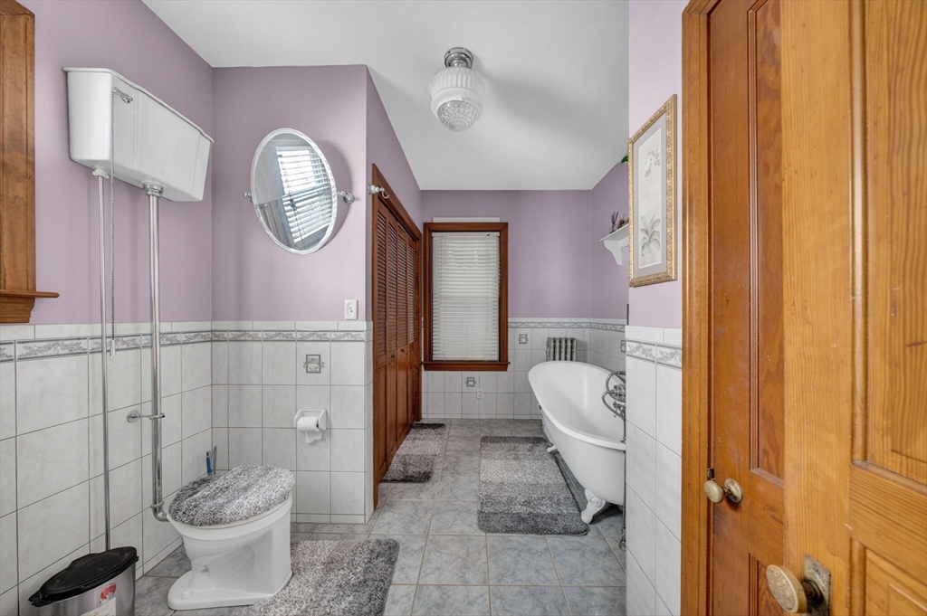 114 Lovell Street Worcester, MA 01603 - Photo 18 of 32 a bathroom with a toilet a sink and a mirror