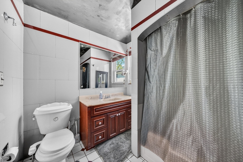 114 Lovell Street Worcester, MA 01603 - Photo 19 of 32 a bathroom with a toilet a sink and a mirror