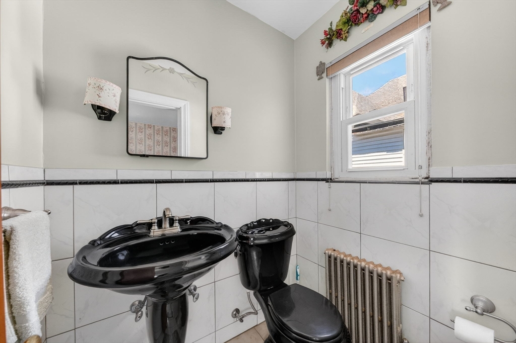 114 Lovell Street Worcester, MA 01603 - Photo 20 of 32 a bathroom with a sink a toilet and a mirror