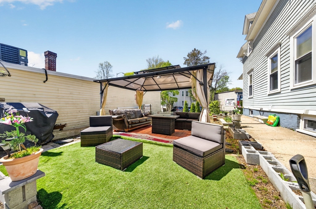 114 Lovell Street Worcester, MA 01603 - Photo 26 of 32 a view of a patio with couches and chairs under an umbrella
