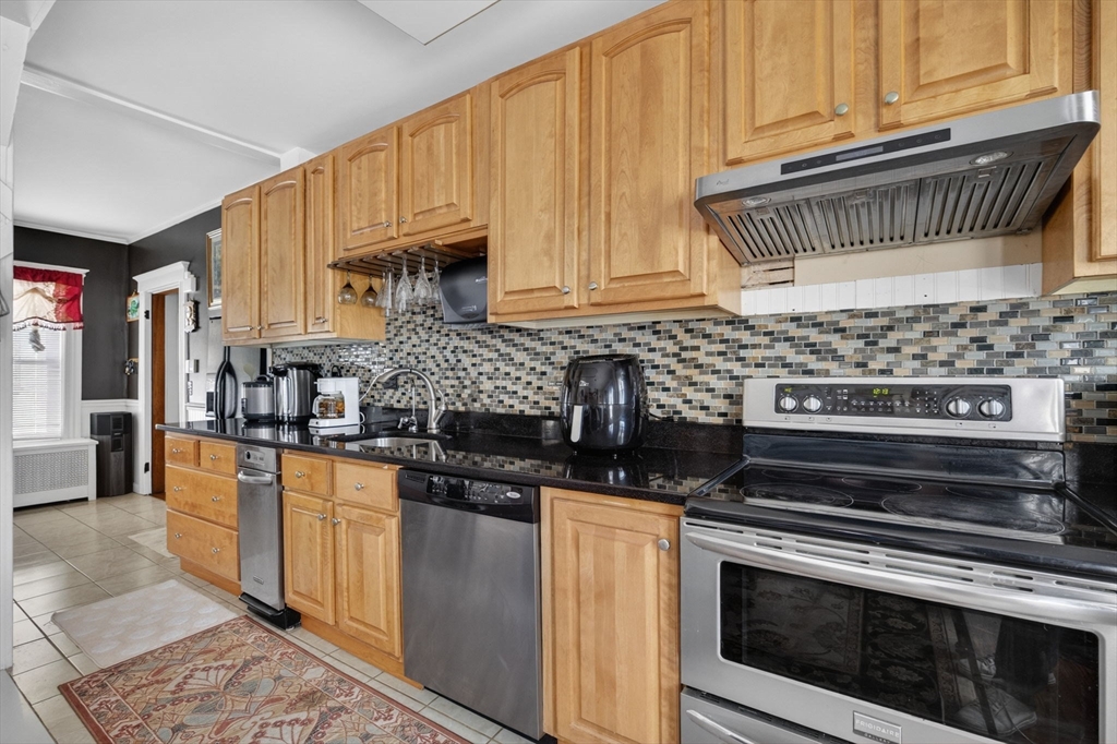 114 Lovell Street Worcester, MA 01603 - Photo 3 of 32 a kitchen with stainless steel appliances granite countertop a stove and a cabinets