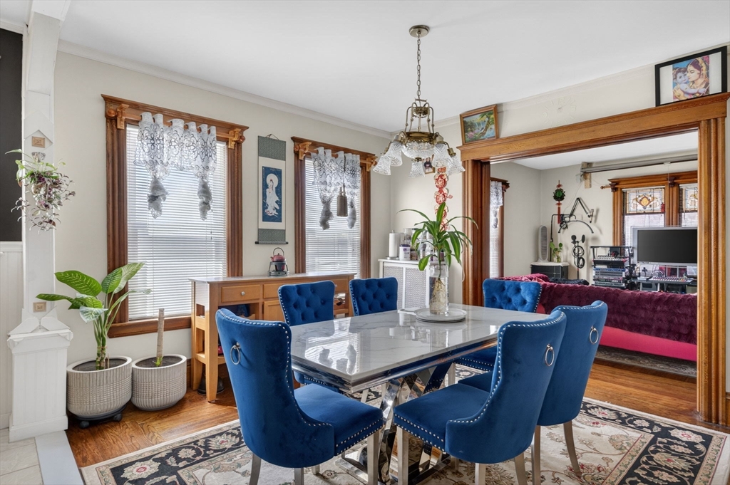 114 Lovell Street Worcester, MA 01603 - Photo 4 of 32 a dining room with furniture a chandelier and wooden floor