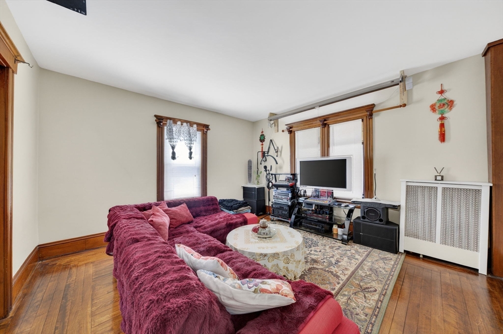 114 Lovell Street Worcester, MA 01603 - Photo 8 of 32 a living room with furniture and a flat screen tv