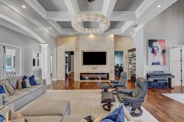 a living room with furniture flat screen tv and wooden floor