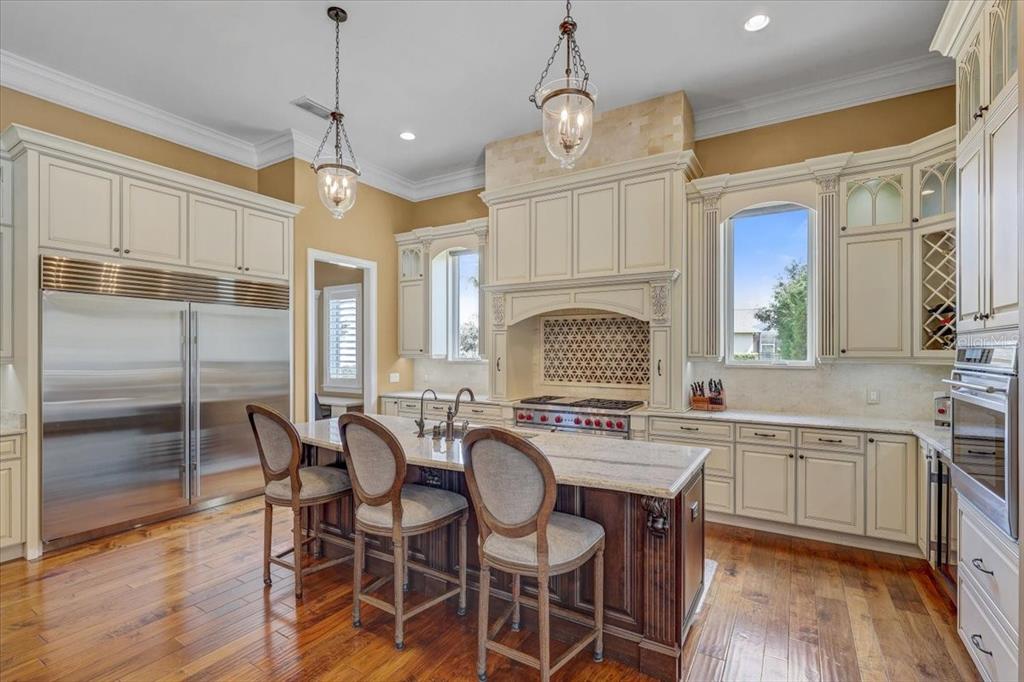2620 Tylers Riv Run Lutz, FL 33559 - Photo 19 of 87 a open kitchen with stainless steel appliances granite countertop a dining table chairs and wooden floor