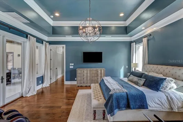 a view of a livingroom with wooden floor and a ceiling fan