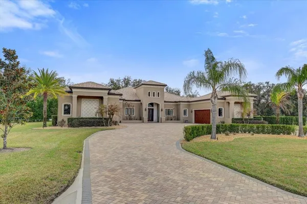 an aerial view of a house with swimming pool garden and trees