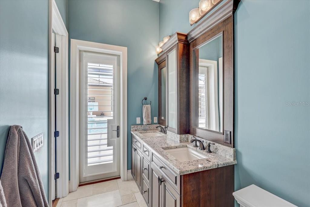 2620 Tylers Riv Run Lutz, FL 33559 - Photo 52 of 87 a bathroom with a granite countertop sink toilet and mirror