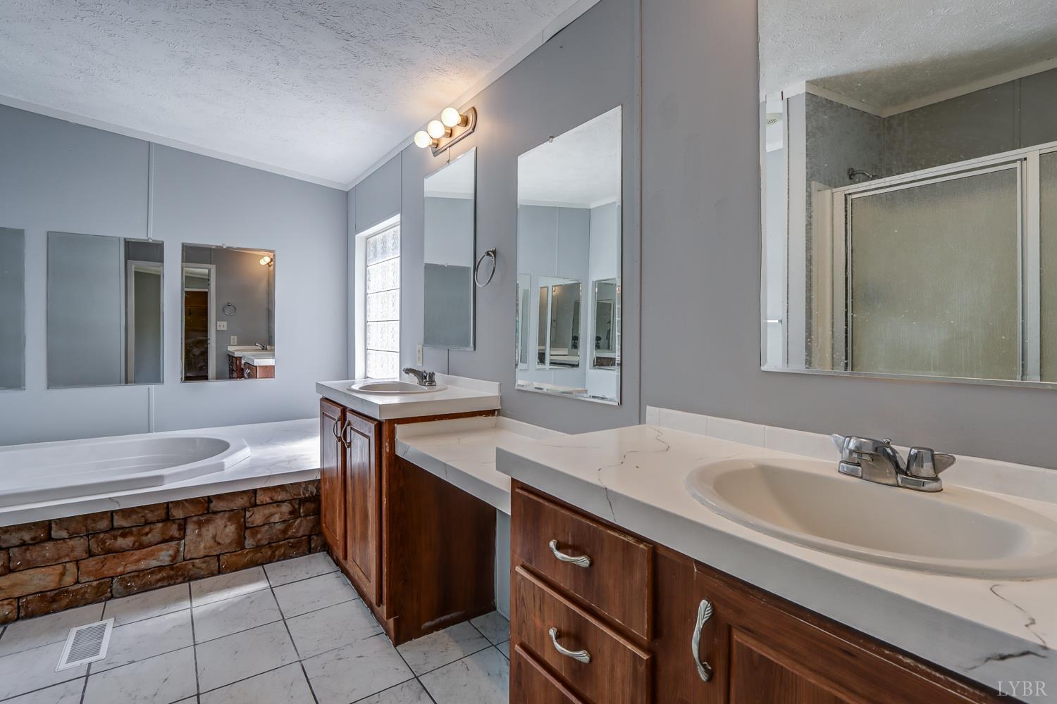 102 Slow Water Court Sandy Level, VA 24161 - Photo 27 of 66 a spacious bathroom with a sink double vanity granite and a mirror