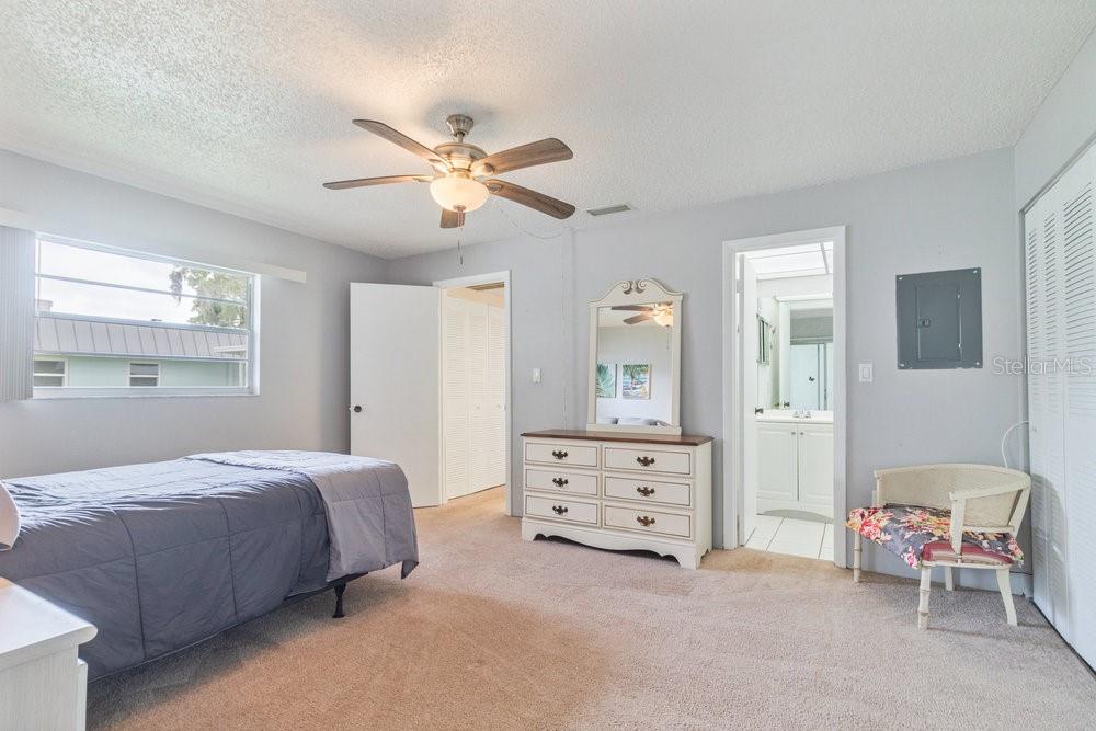 11723 Boynton Lane, Unit 1 New Port Richey, FL 34654 - Photo 11 of 31 a bedroom with a bed and a cabinets