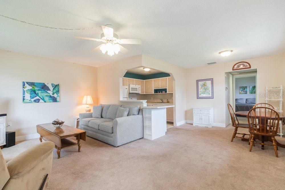 11723 Boynton Lane, Unit 1 New Port Richey, FL 34654 - Photo 18 of 31 a living room with furniture and a window