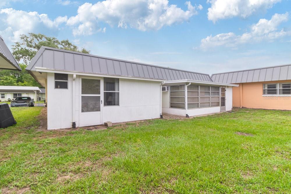 11723 Boynton Lane, Unit 1 New Port Richey, FL 34654 - Photo 20 of 31 a view of a house with a yard