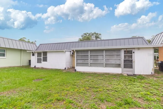 a view of a house with a yard and garage