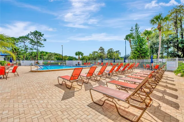 a view of swimming pool with sitting area