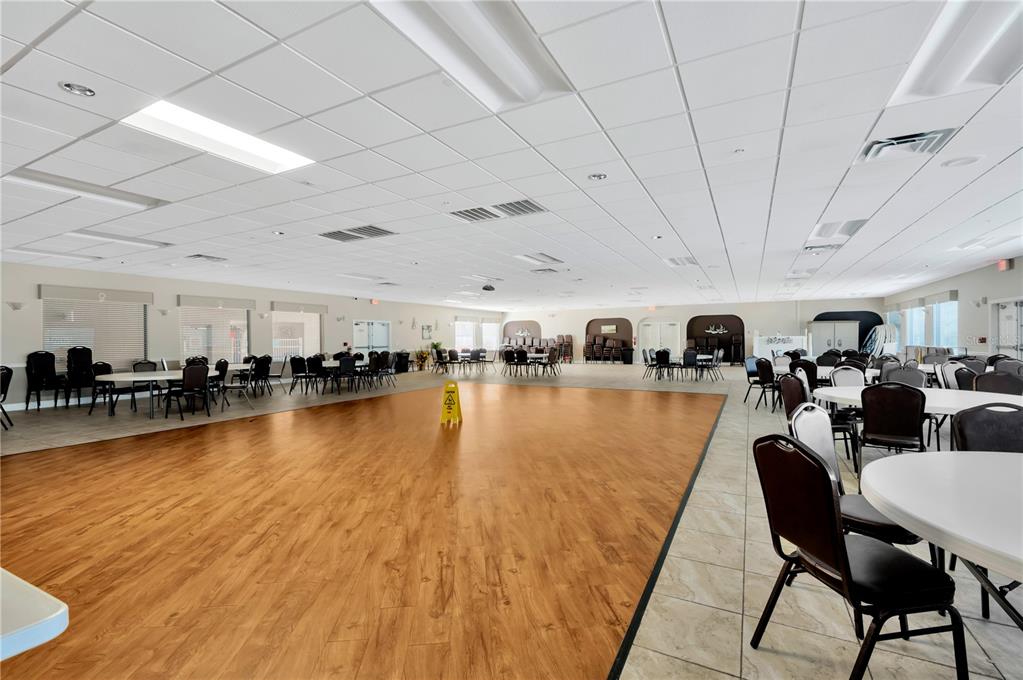11723 Boynton Lane, Unit 1 New Port Richey, FL 34654 - Photo 28 of 31 a living room with lots of furniture and a swimming pool