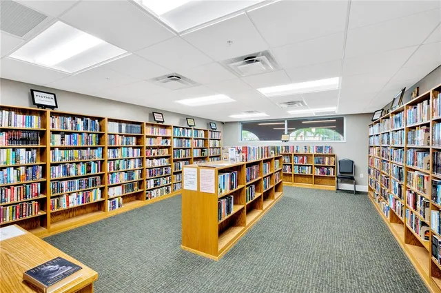 a room with lots of furniture and book shelf