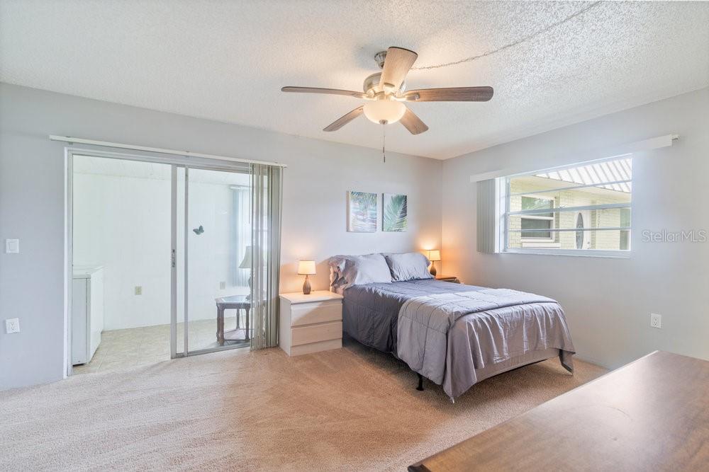 11723 Boynton Lane, Unit 1 New Port Richey, FL 34654 - Photo 7 of 31 a spacious bedroom with a bed and closet