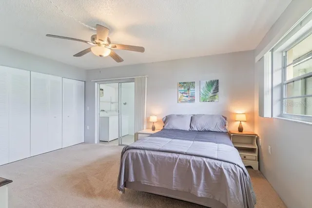 a bedroom with a large bed and a chandelier