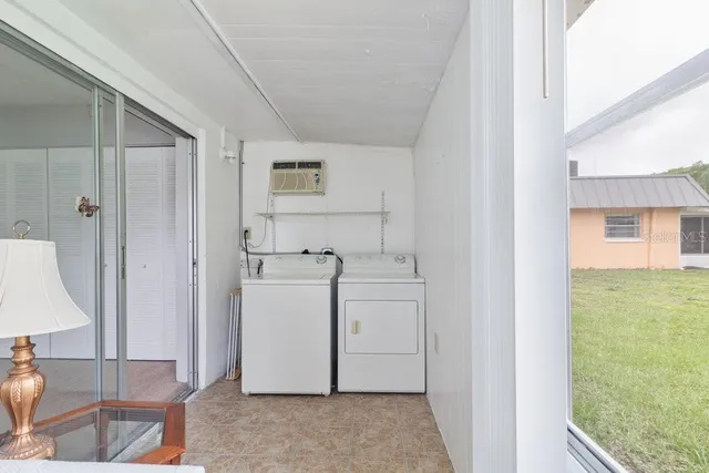 a utility room with cabinets washer and dryer