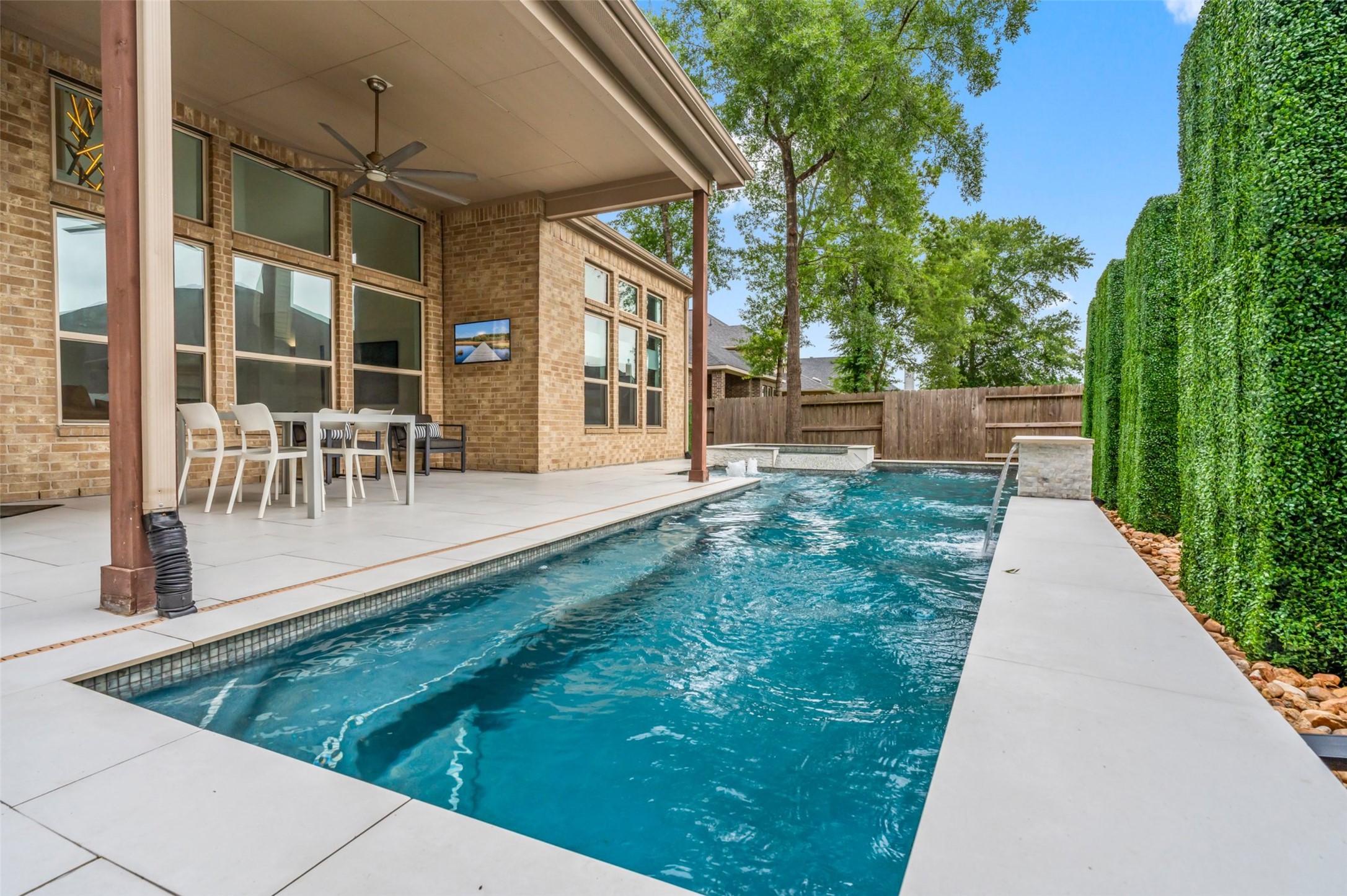 1053 Bat Hawk Court Conroe, TX 77385 - Photo 1 of 50 a view of a patio with table and chairs and potted plants