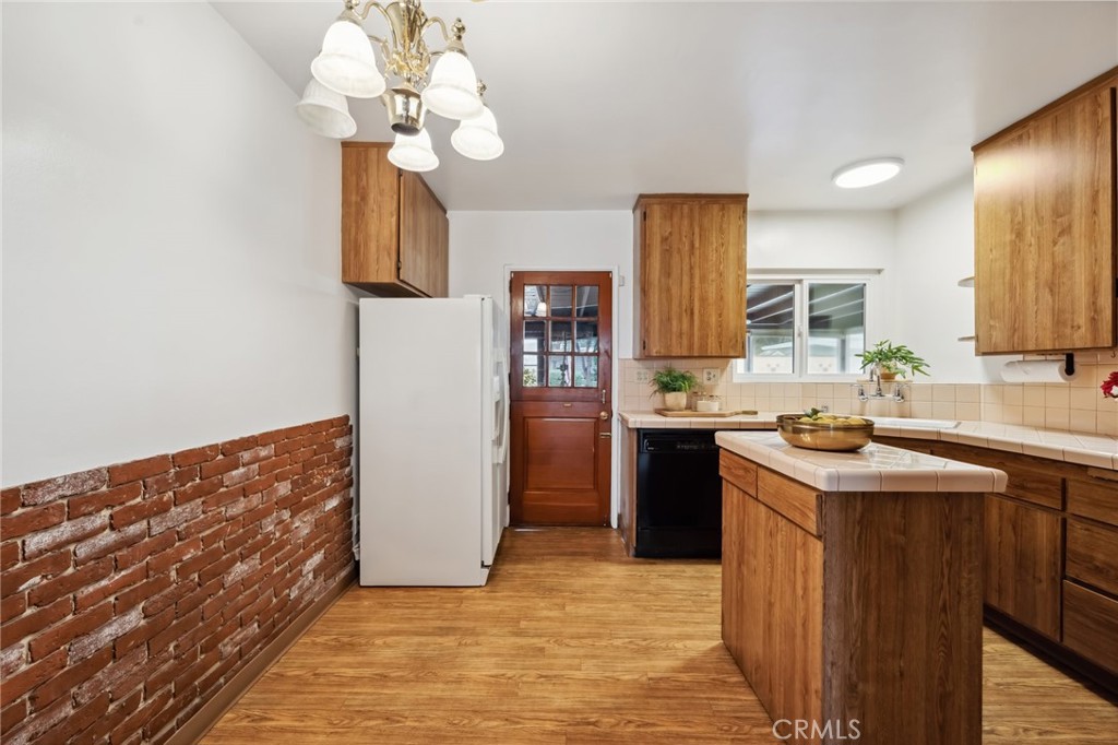 3035 Priscilla Street Riverside, CA 92506 - Photo 13 of 45 a kitchen with a sink a counter top space and stainless steel appliances