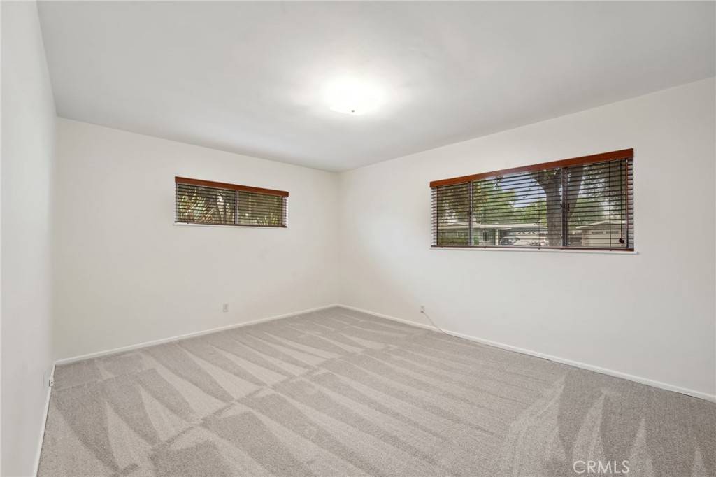 3035 Priscilla Street Riverside, CA 92506 - Photo 18 of 45 a view of an empty room with wooden floor and a window