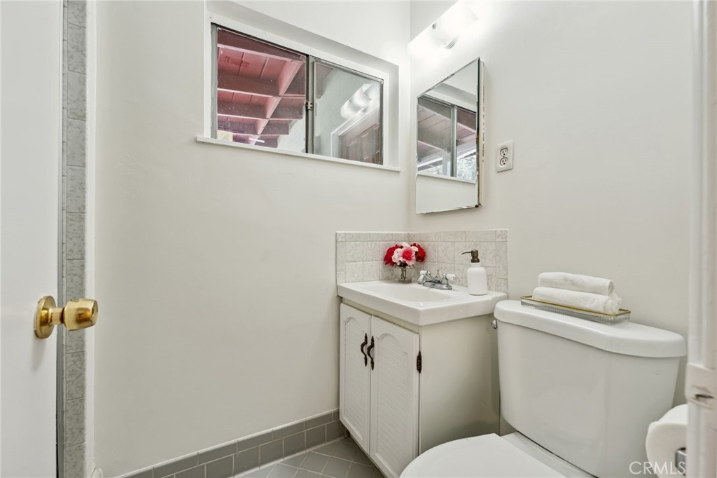 3035 Priscilla Street Riverside, CA 92506 - Photo 22 of 45 a white toilet sitting next to a bathroom sink