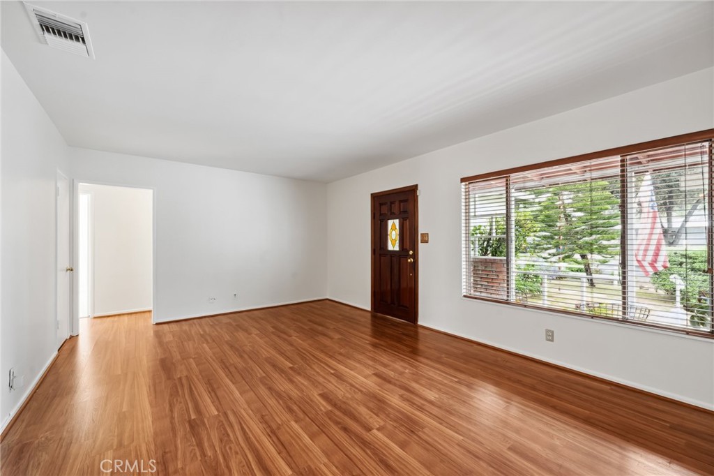 3035 Priscilla Street Riverside, CA 92506 - Photo 7 of 45 a view of an empty room with wooden floor and a window