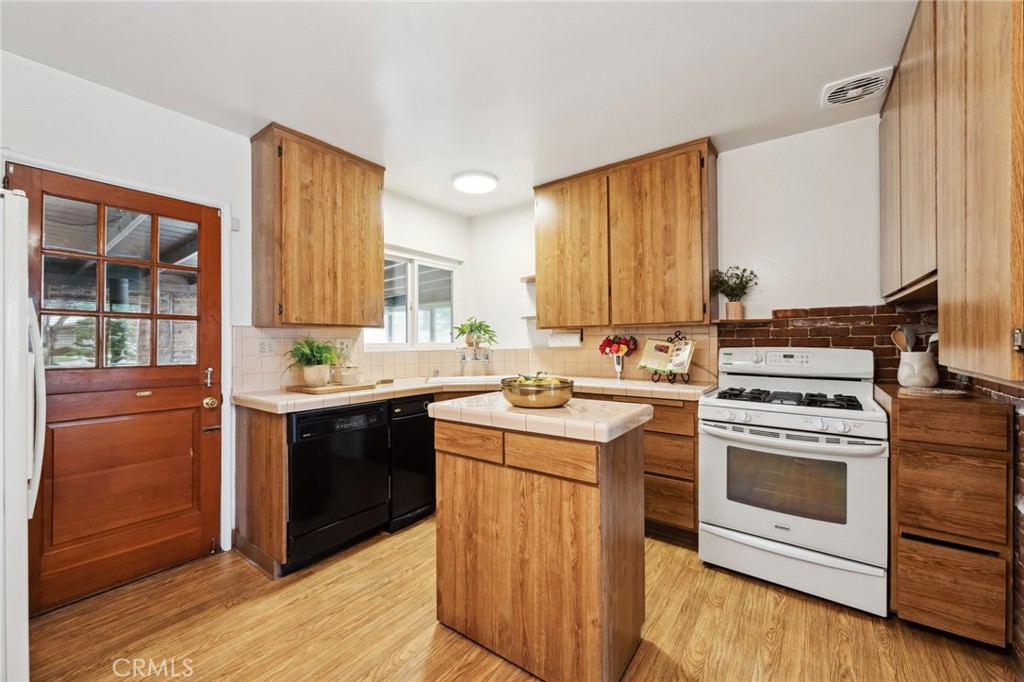 3035 Priscilla Street Riverside, CA 92506 - Photo 10 of 45 a kitchen with a stove top oven sink and cabinets