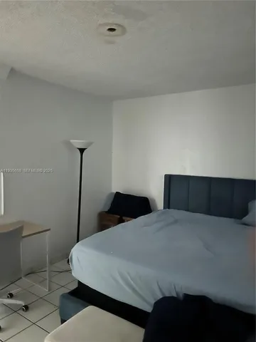 a bedroom with a bed and a toilet