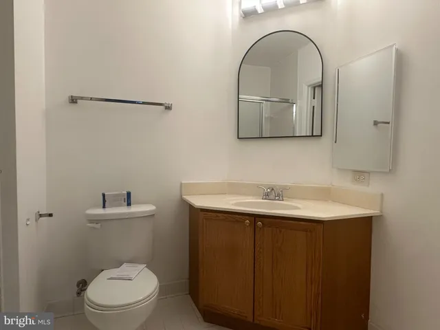 a bathroom with a sink a toilet and mirror
