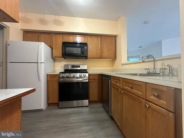 a kitchen with a refrigerator stove and sink
