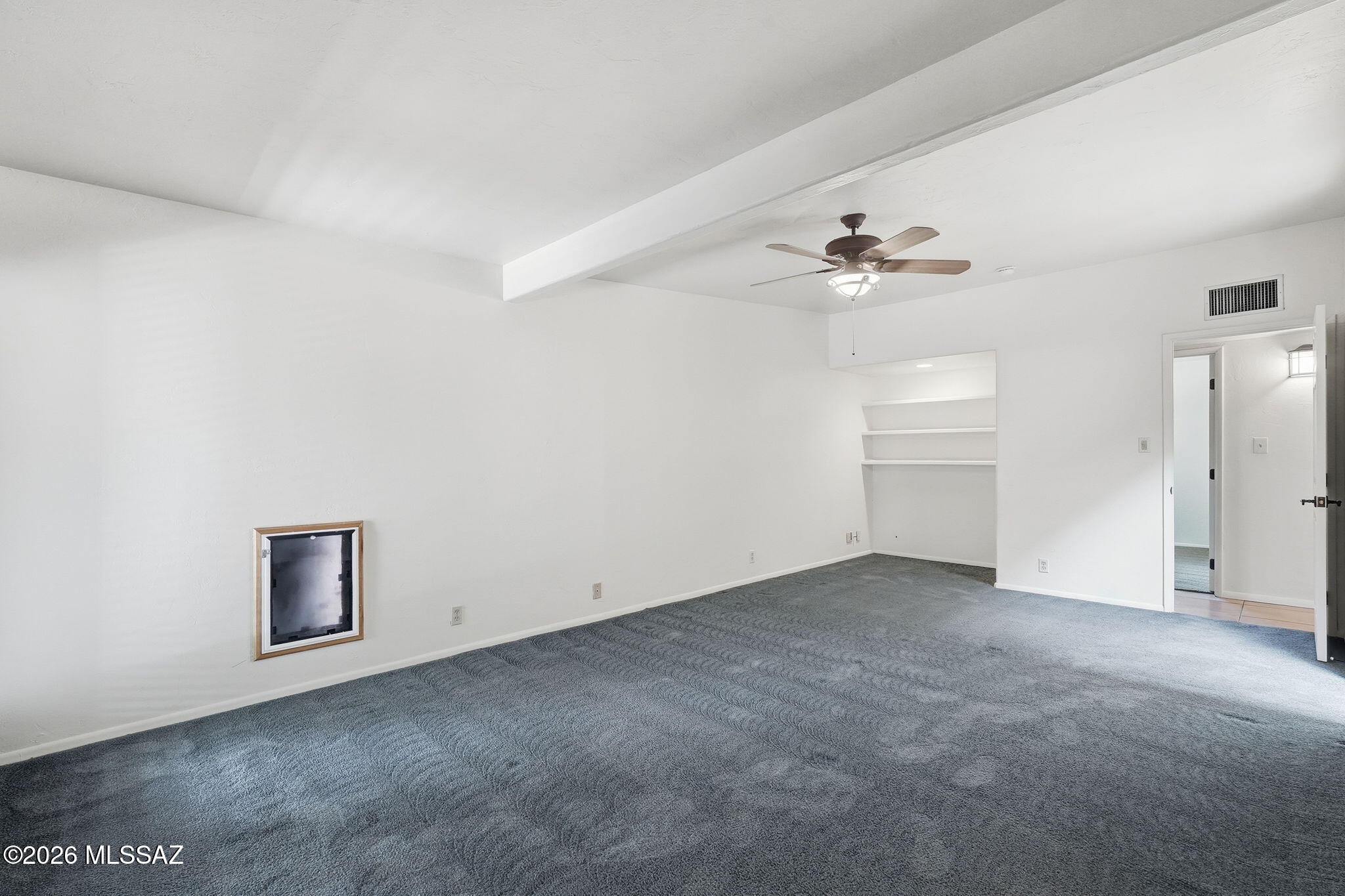 1125 East Kleindale Road Tucson, AZ 85719 - Photo 18 of 49 an empty room with a chandelier fan and windows