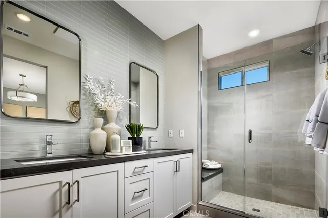a bathroom with a double vanity sink and mirror
