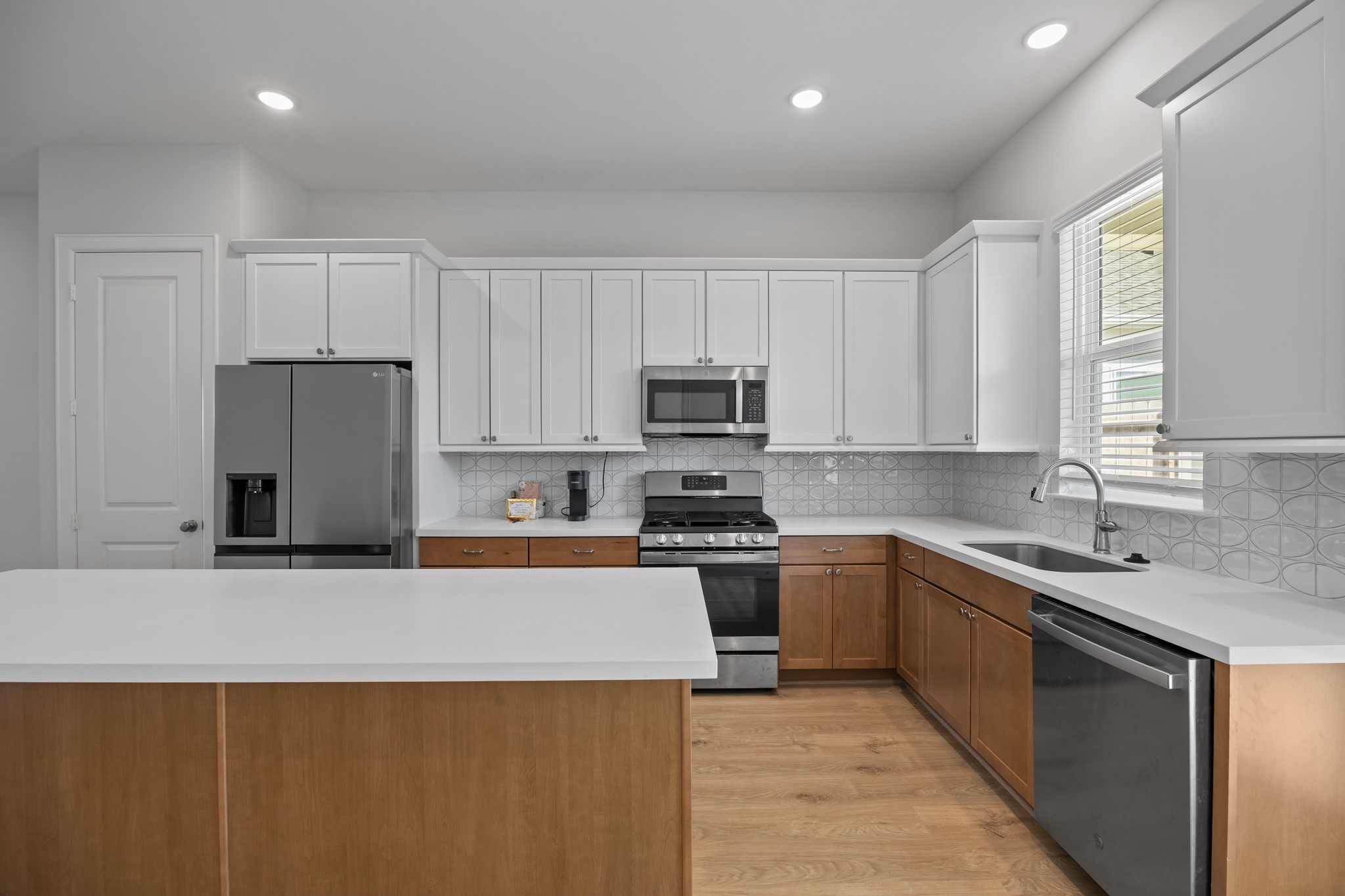 2505 South Houston Avenue Pearland, TX 77581 - Photo 6 of 24 a kitchen with stainless steel appliances granite countertop a sink stove and refrigerator