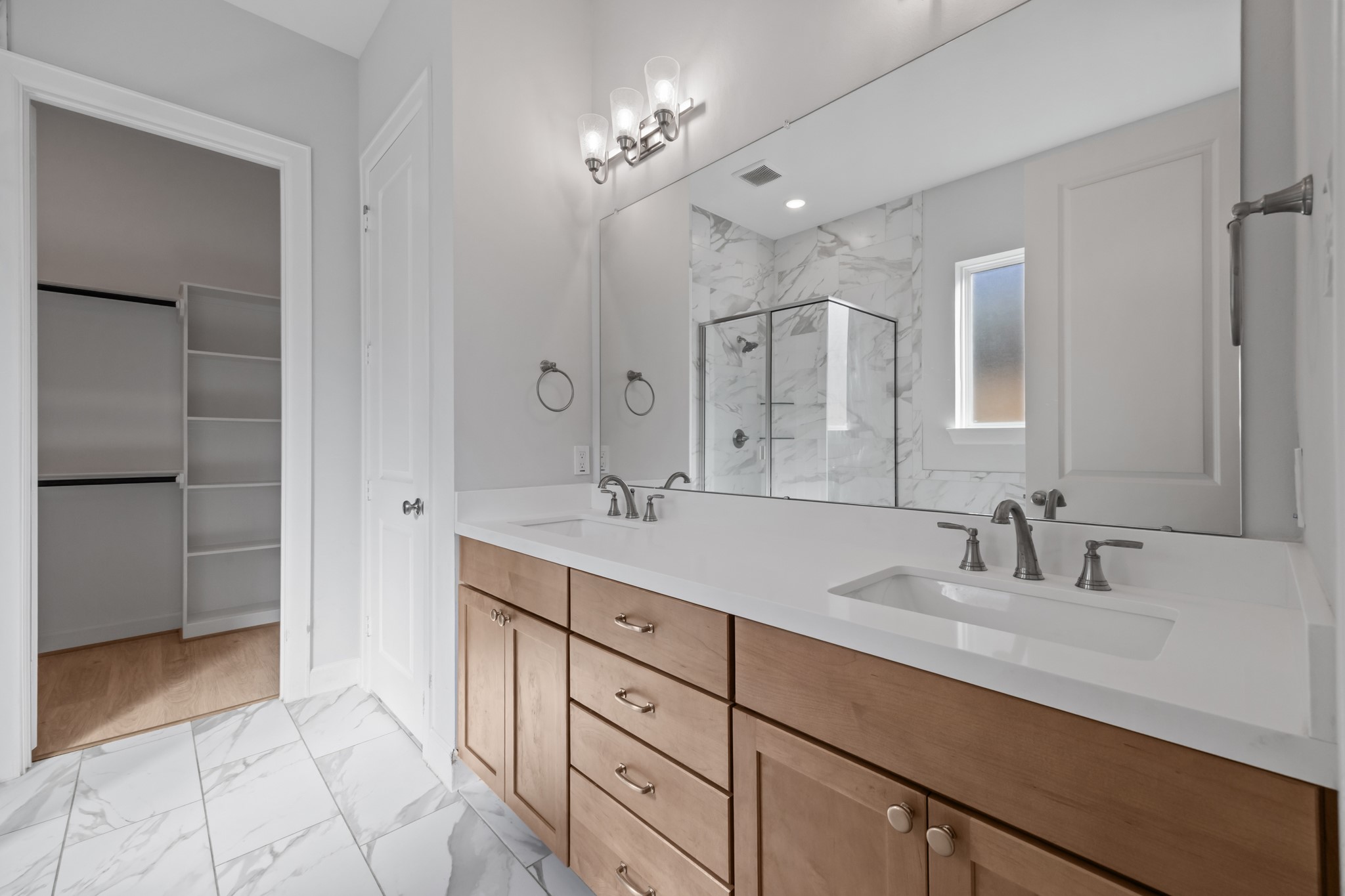 2505 South Houston Avenue Pearland, TX 77581 - Photo 10 of 24 a bathroom with a double vanity sink a mirror and a shower