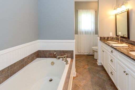 228 Wabash Road Fayetteville, TN 37334 - Photo 14 of 50 a bathroom with a tub a sink and a large window