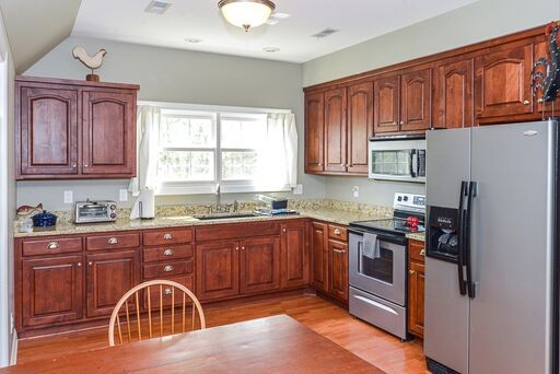 228 Wabash Road Fayetteville, TN 37334 - Photo 31 of 50 a kitchen with stainless steel appliances granite countertop a stove top oven a sink dishwasher and cabinets with wooden floor