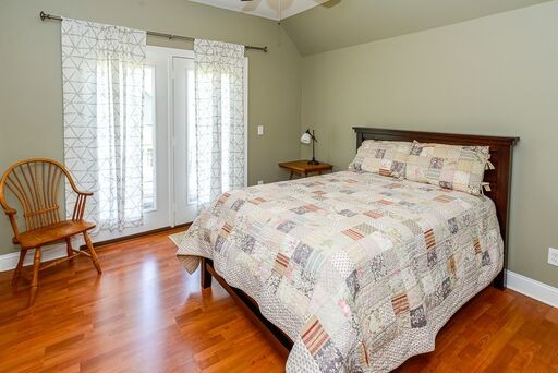 228 Wabash Road Fayetteville, TN 37334 - Photo 33 of 50 a bedroom with a bed a chair and a large window